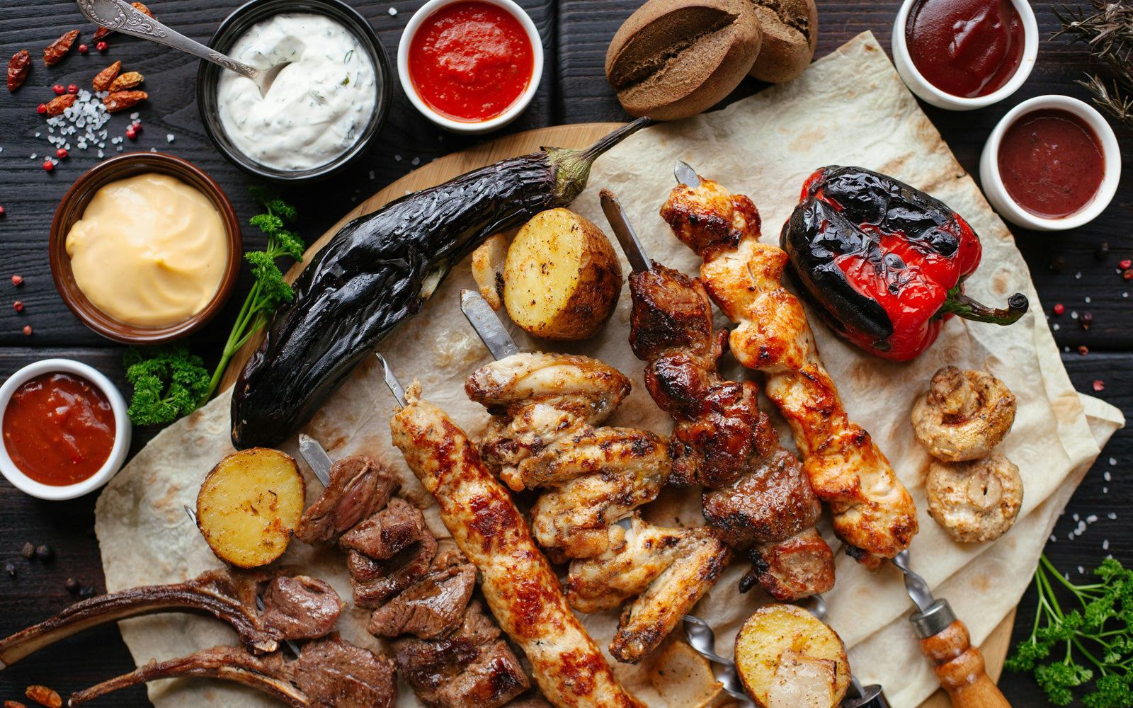 Assorted grilled veggies & meats with sauces & spices