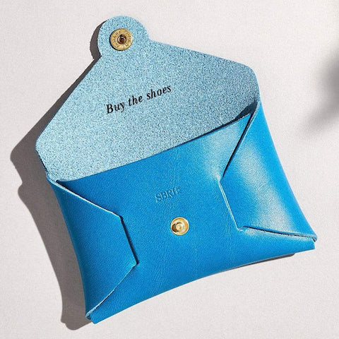 Sbri sky blue leather coin purse with message "buy the shoes"