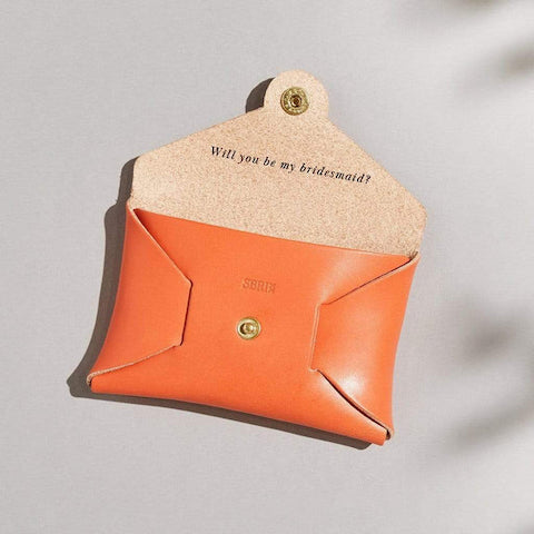 Sbri orange leather coin purse with message "will you be my bridesmaid?"