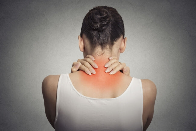Image of a woman holding her neck in pain.
