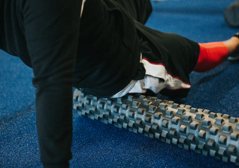 Image of a man foam rolling after exercise.