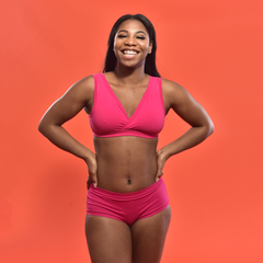 Model is wearing a bright pink underwear set.