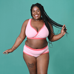 Kayla is wearing a pale pink Candyfloss Original underwear set against a teal background