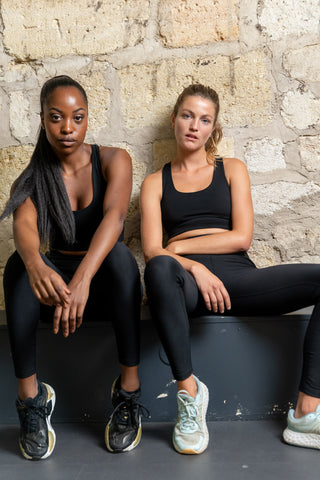 Two women in the gym wearing Tripulse high-performing, skin-friendly and toxin-free Original Leggings and Sports Bra  in black.