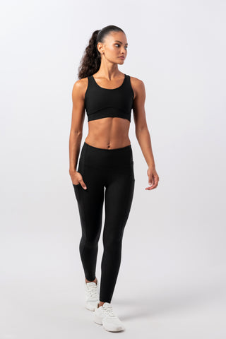 Woman posing in different positions wearing Tripulse Original Leggings and sports bra in black.