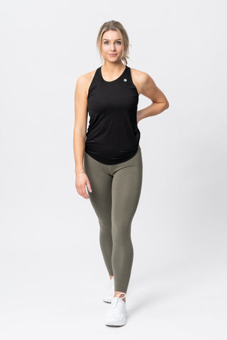 Woman modelling against a white background wearing Tripulse Pro working leggings in colour khaki and tank top in black.