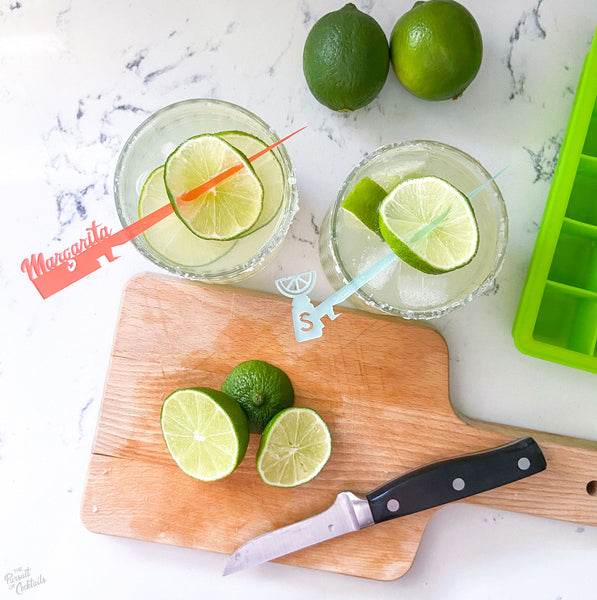 Sparkling Margarita Pitcher recipe garnish with limes and Swizzly Sticks from The Pursuit of Cocktails