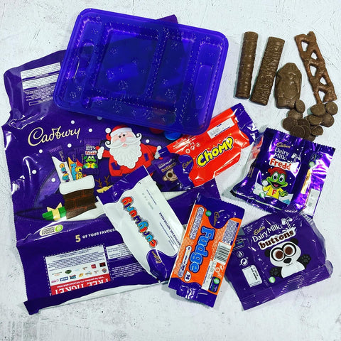 Wrapped and chocolate laid out from a cadburys selection box