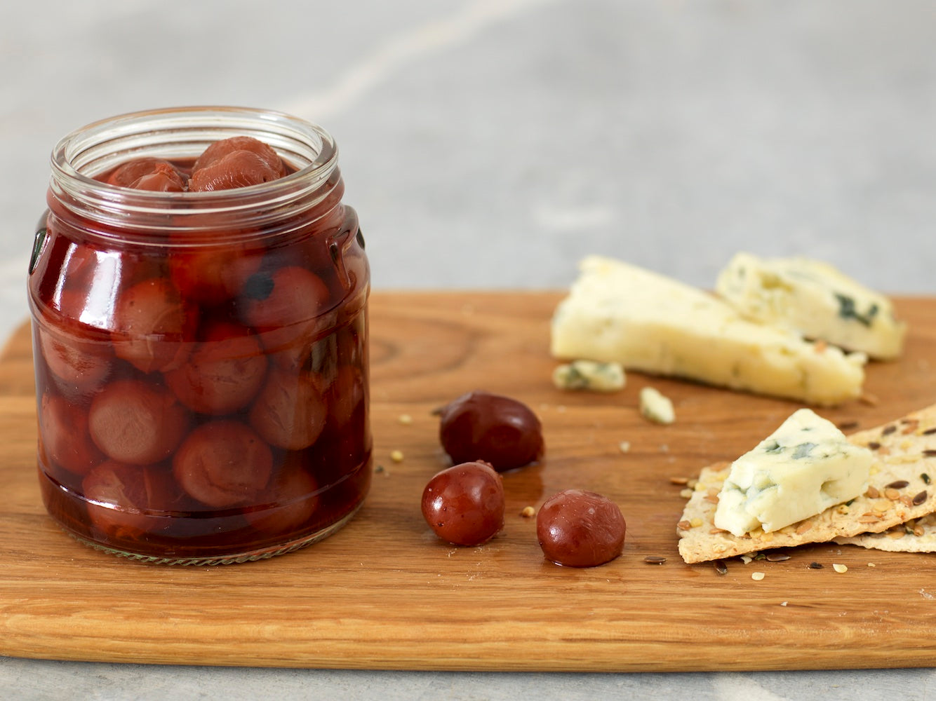 Pickled grapes with cheese and crackers