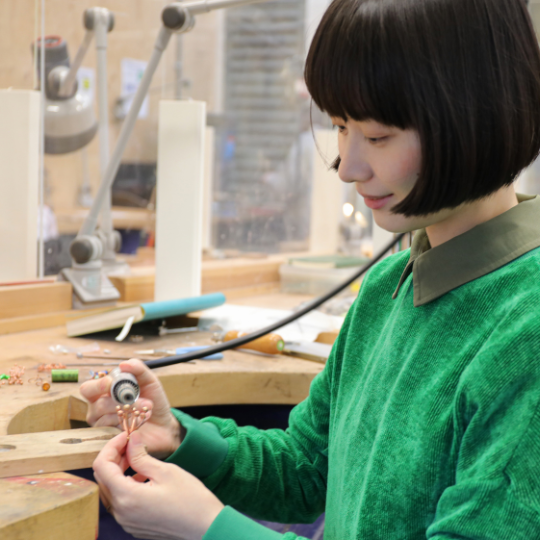 Jeweller Xinyin Chen working her jewellery workbench