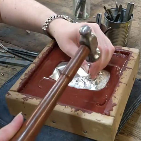 Silversmith Alice Fry chasing a piece of silver 