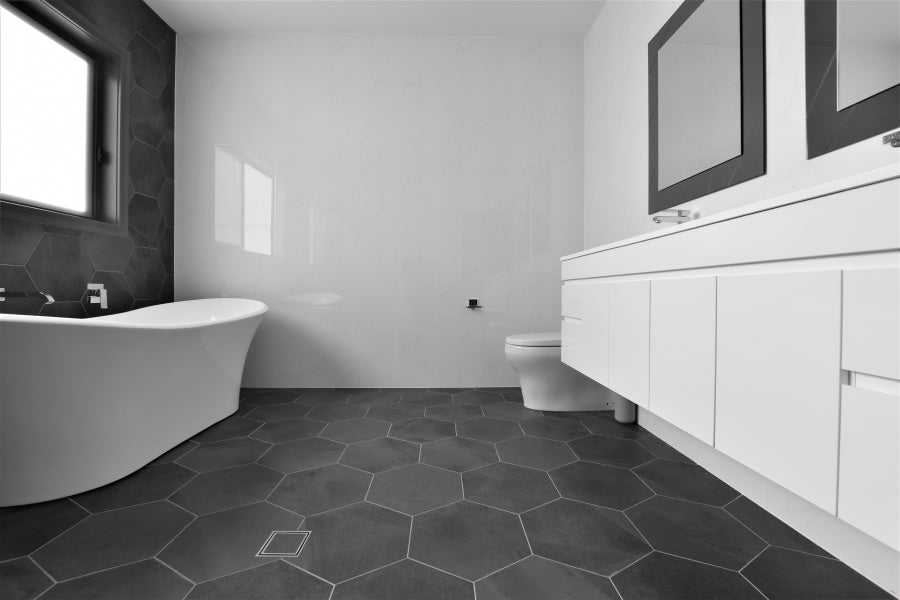 #84 - Bathrooms: Hexagonal charcoal tiles contrast against all-white w