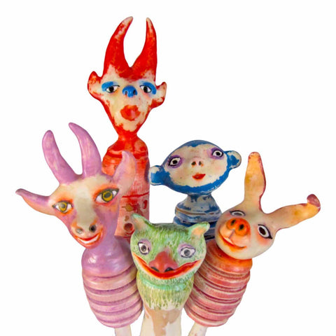 Colorful painted sculptures on sticks with sweet faces of a funny group of characters from Twinki-Winki by Alex Mitchell.