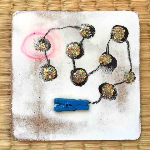 Square painting with connected gold dots and tiny blue clothes clip on white background by Alex Mitchell.