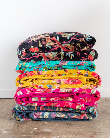 Paradise velvet quilted throws in a stack