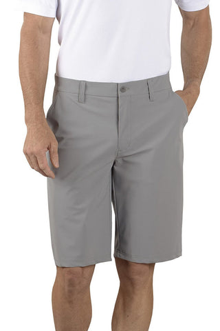man wearing golf shorts and a white shirt with his left hand in pocket