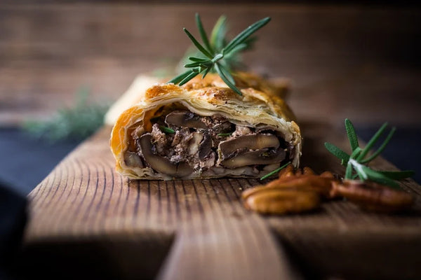 A Vegan mushroom Wellington sliced to see the inside mushrooms and gravy. A fantastic Christmas Centrepiece