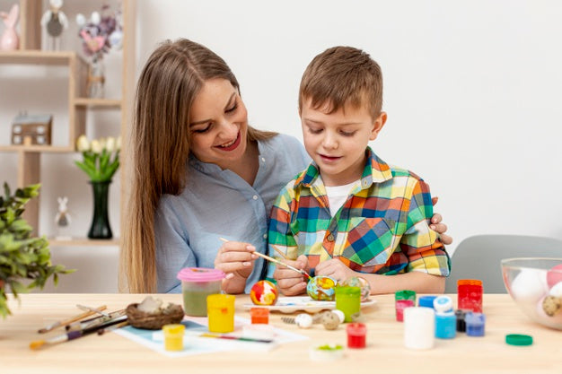 young mom sonpainting egg easter