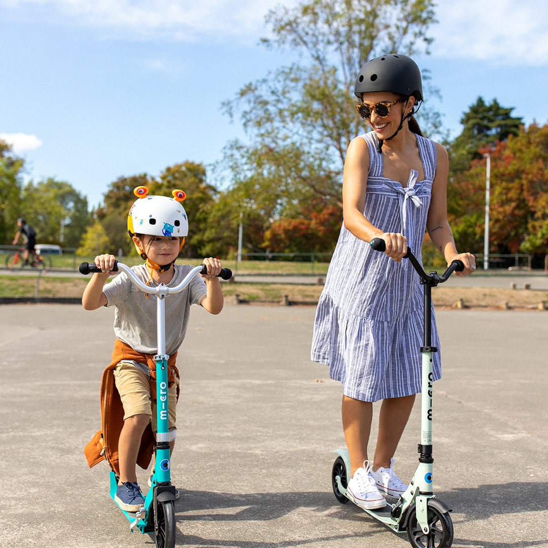 mother and son at the skate park on 2 wheel micro scooters