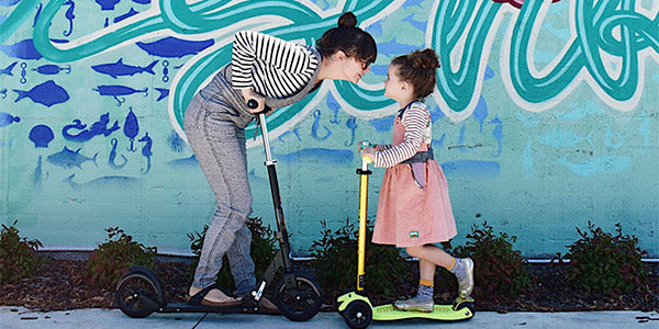 mum and daughter having fun on their scooters