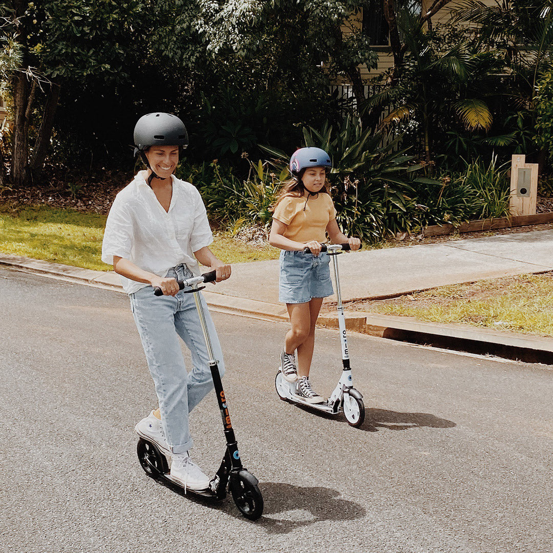 mum and daughter riding adult scooters