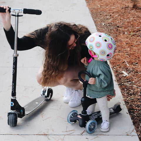 Mum with her daughter on a Mini Micro seat for toddlers