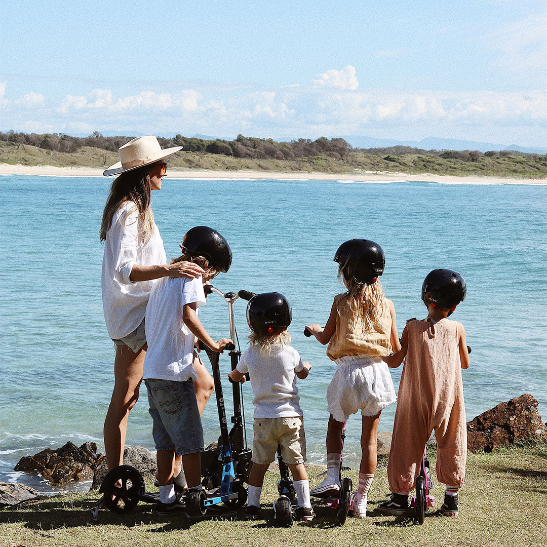 mum and her four children with their favourite kids and adult scooters