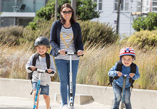 Mum scooting the school run with kids