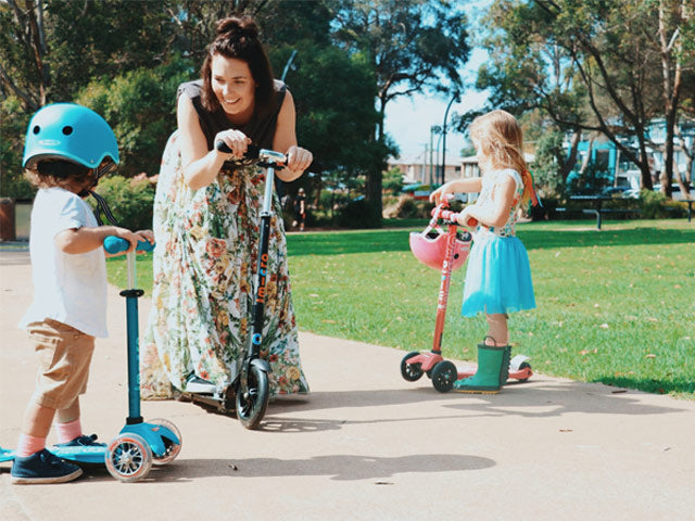 Mum scooting with her kids 
