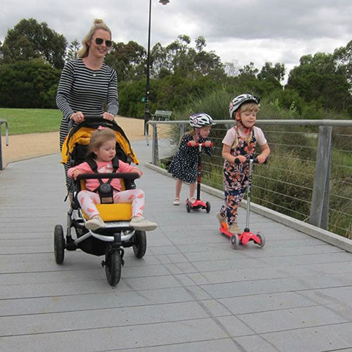 Adrienne scooting with her kids 