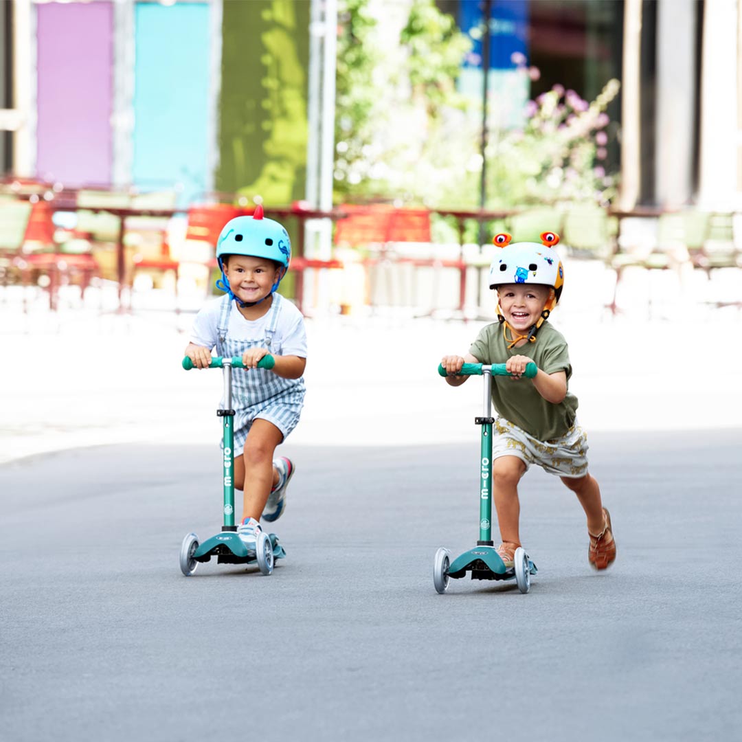 toddlers racing on their mini eco 3 wheel scooters