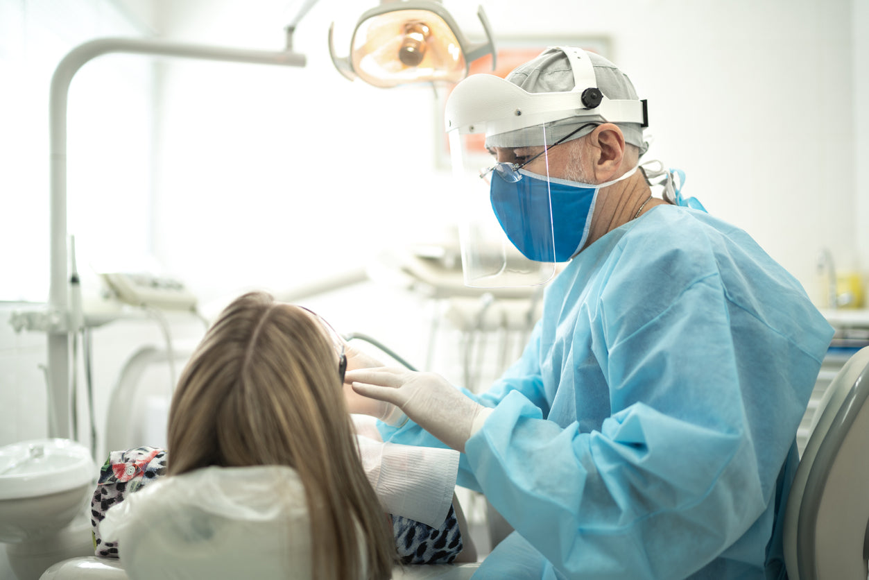 Dentist working on patient | dental medical waste management Discount Disposables