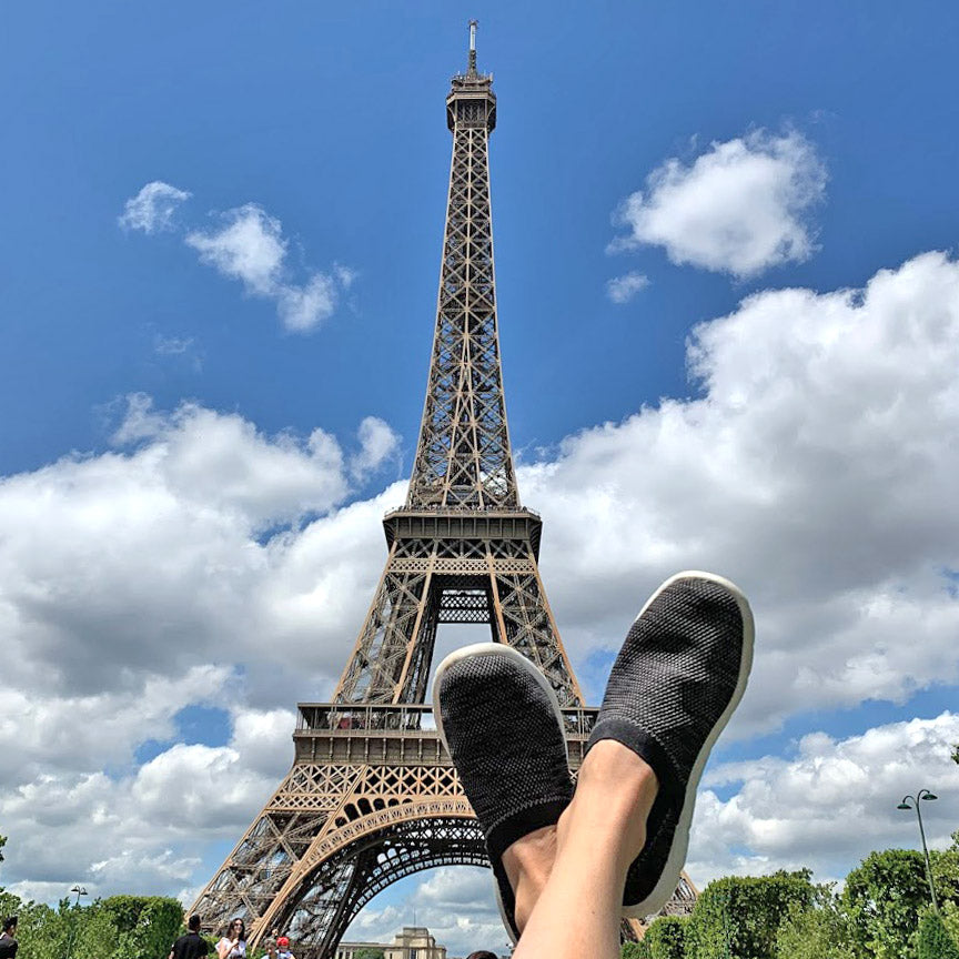 Women's Harmony Zenz in Black Marbled on model with her feet up and the Eiffel Tower in the background