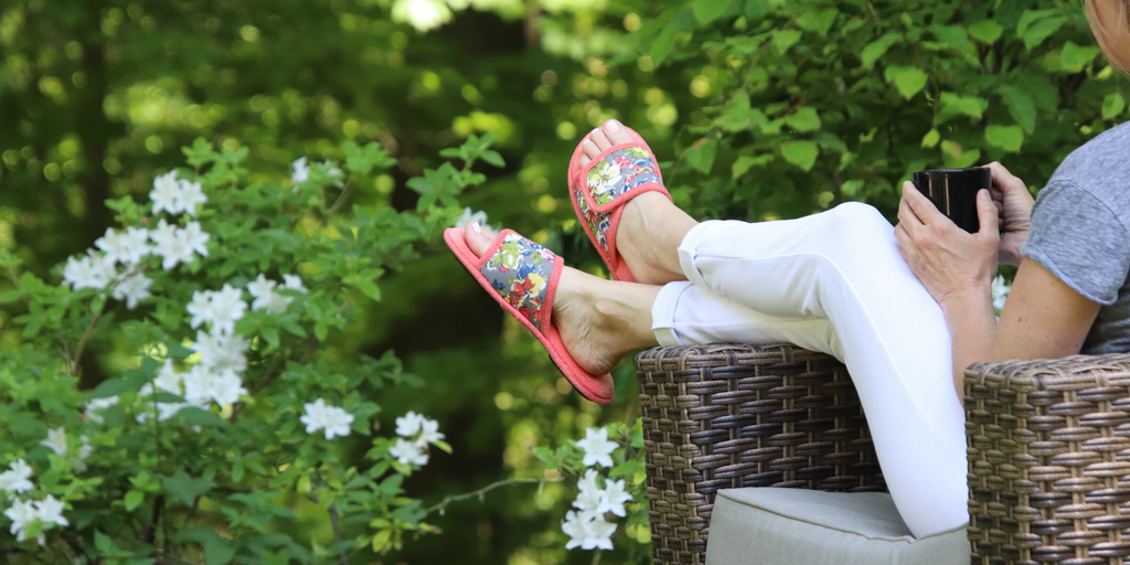 Petunia Floral Slide on figure sitting on a chair overlooking a lush backyard