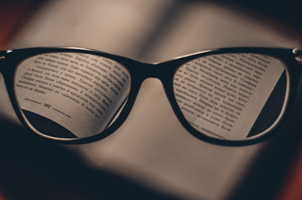 glasses focused on a book 