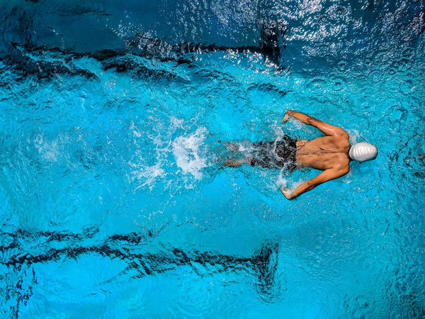 A man swimming down a pool lane