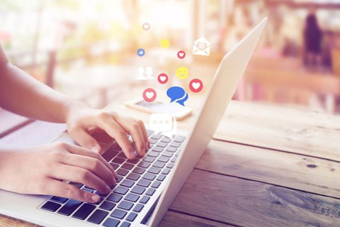 Reach out on cancer support groups - Woman typing on laptop