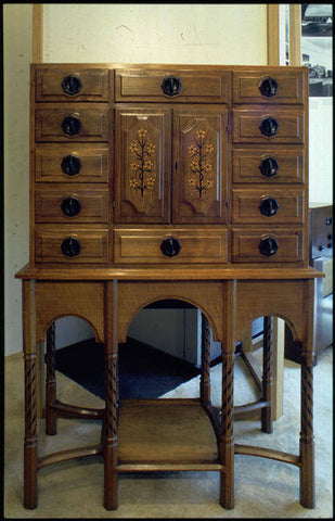 Cabinet in English walnut inlaid with ebony, boxwood and laburnum, designed by Gordon Russell and made by William Marks of Russell & Sons, 1924. Interior (not visible) veneered in Oysterwood. Credit: VADS and The Design Council Slide Collection at Manchester Metropolitan University Special Collections