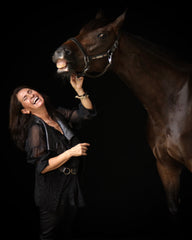 Elma Garcia standing with her dressage horse laughing love