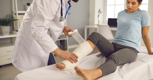 Doctor joining fractured bone of a lady