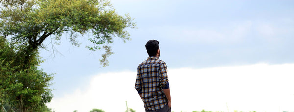 alone man standing next to the tree