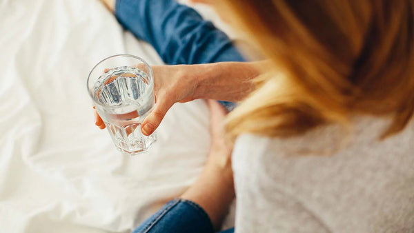 Woman holding glass of filtered water