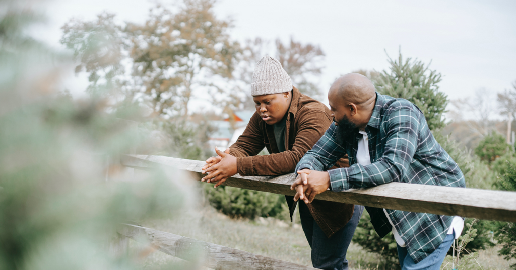 Father and son having a sexual health conversation outdoors.