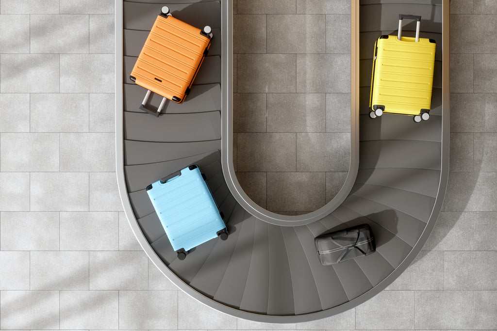 Colourful suitcases on a conveyer belt.