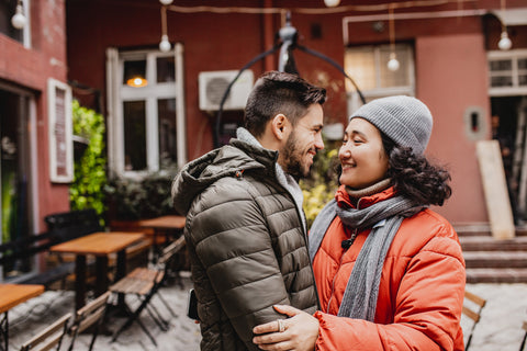 A man and woman tentatively embracing, probably wondering who will make the first move.