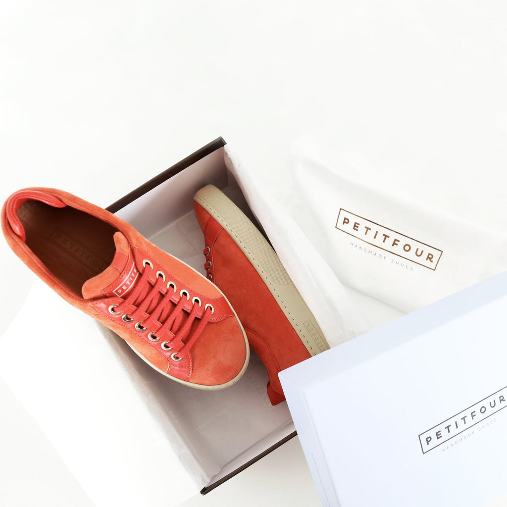 top and side view of orange sneakers papaya small size shoes model from petitfour feeling good collection