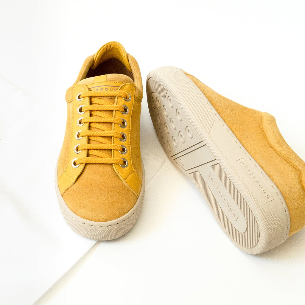 top and side view of yellow sneakers saffron small size shoes model from petitfour feeling good collection