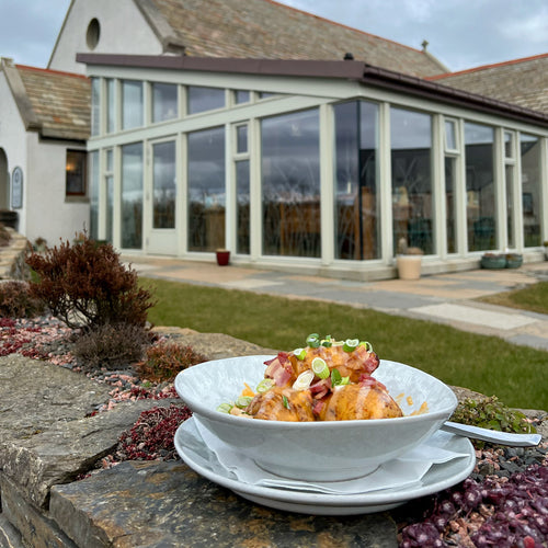 Loaded Hasselback Tatties outside The Kirk Gallery & Café.