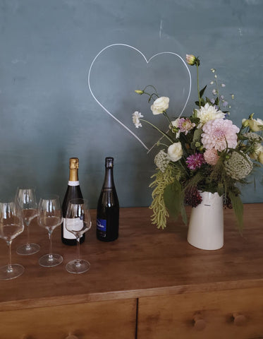 Wine with glasses and a bouquet in vase