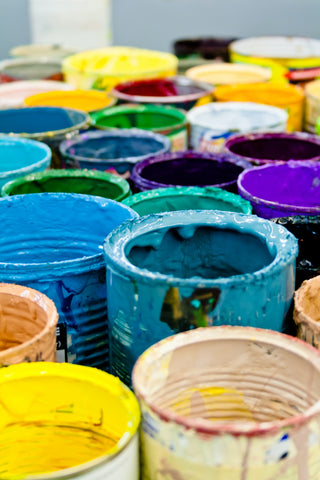 Several open buckets of paint.